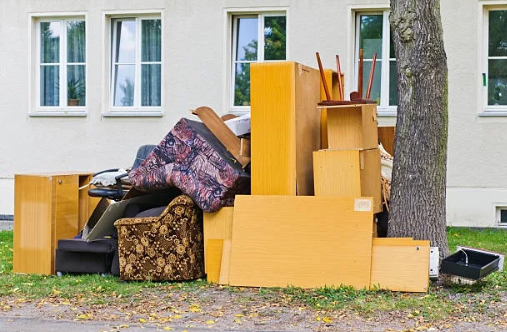 Pile of discarded furniture and household items ready for removal