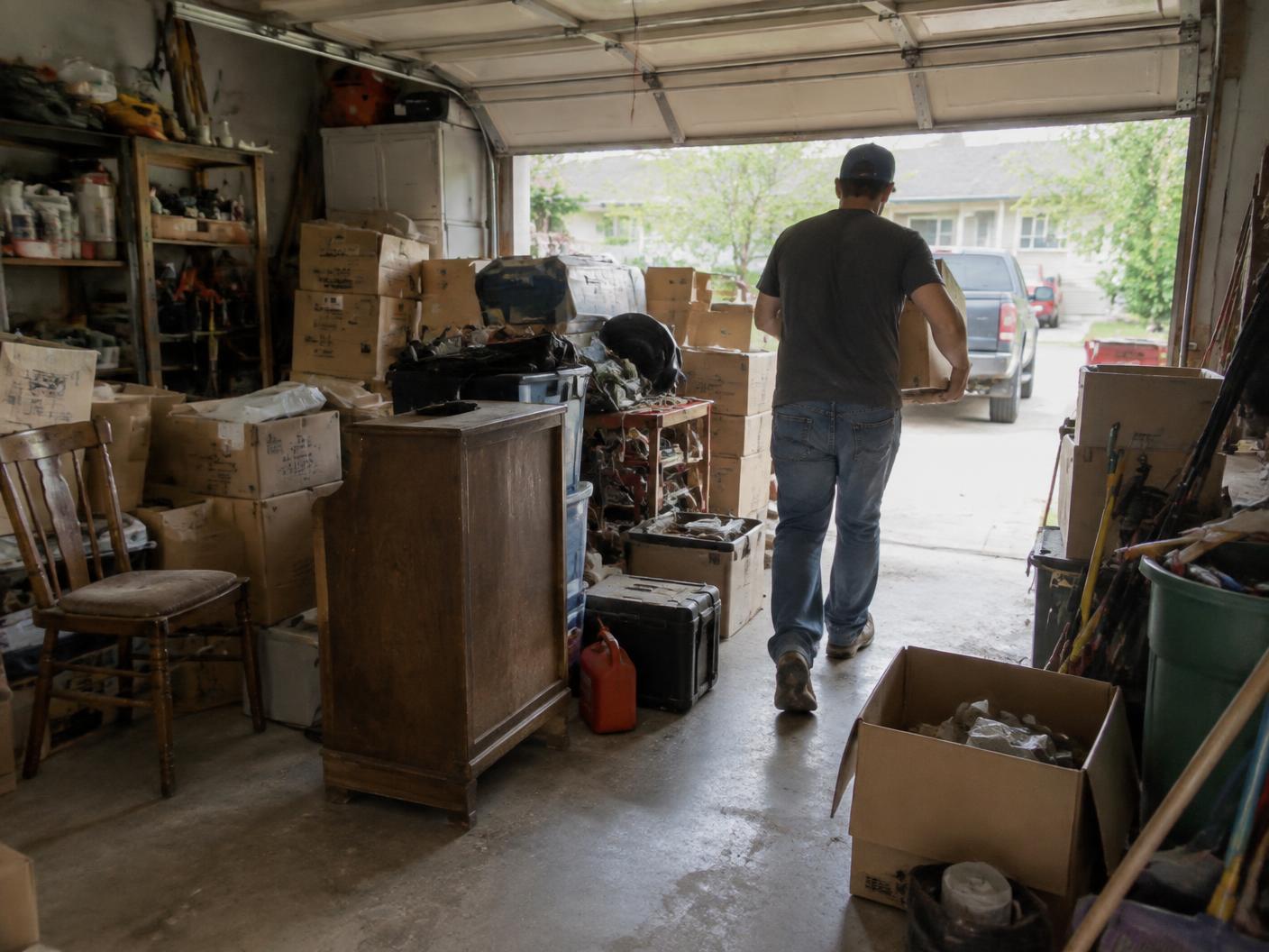 Cluttered residential garage being cleared out