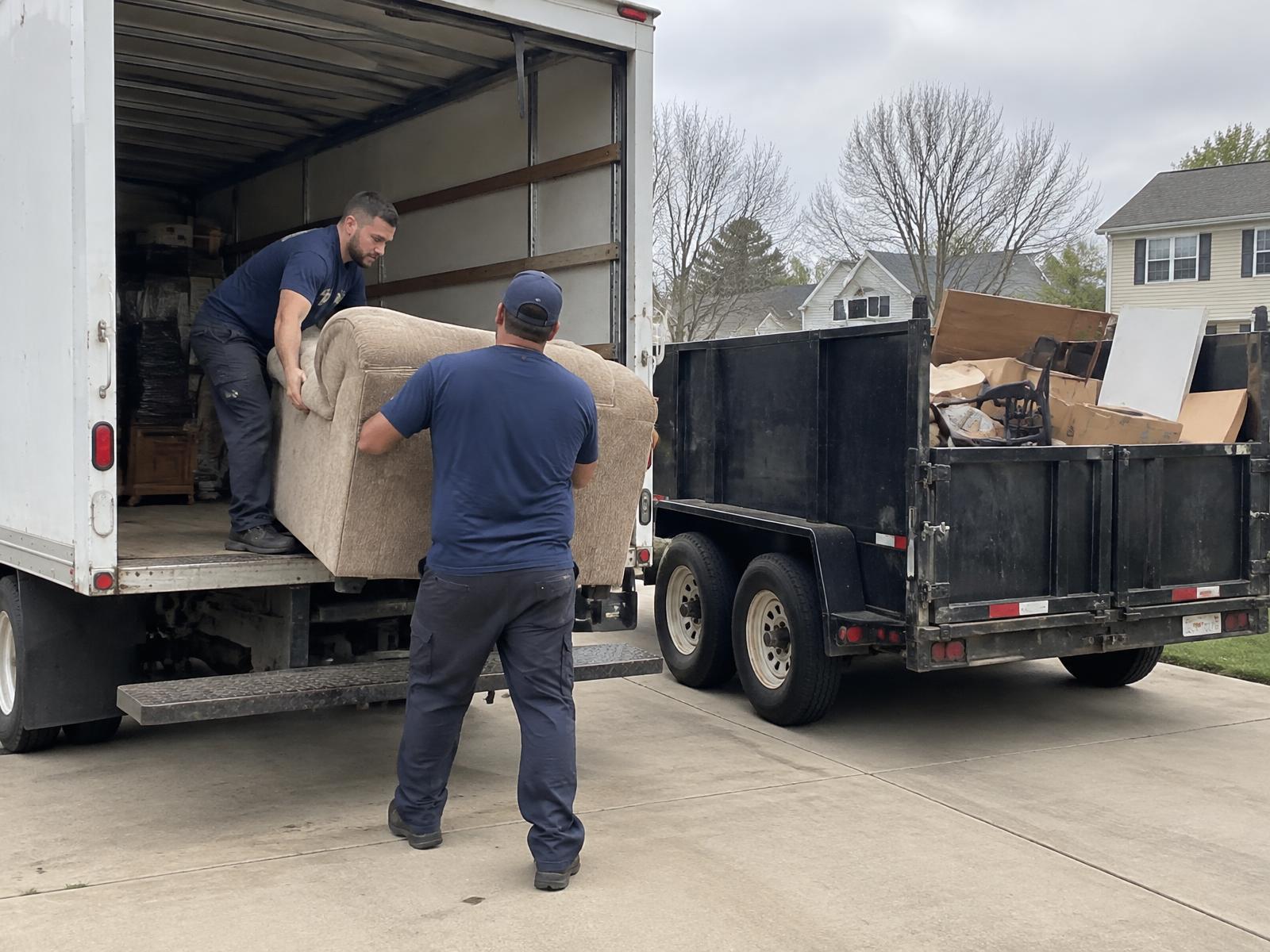 R&J Hauling and Junk Removal crew loading items for hauling